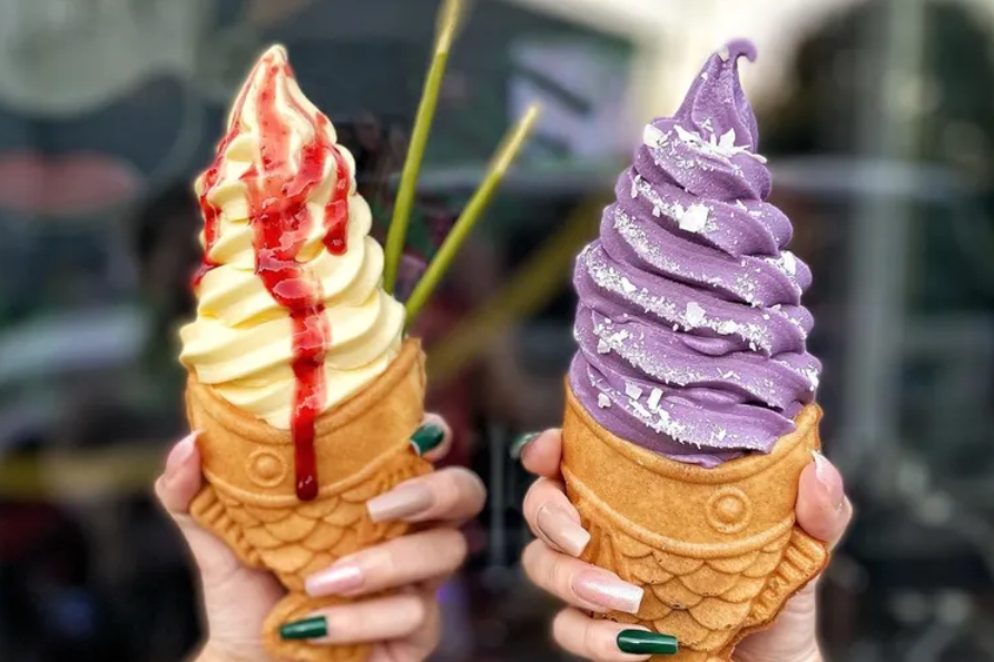 Fish-shaped ice cream. These are some of the options for taiyaki at Matcha Man in Seattle. On the left is pineapple ice cream with strawberry syrup and matcha pocky and on the right is ube ice cream with coconut shavings.