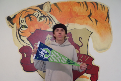 Aaron Bulanov holds the flag of the school he's going to next year. He’s doing Running Start, which is a program where eleventh and twelfth graders go to a community college. Highline is the most popular option for FWPA students.