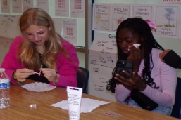 Dressed for Success! Julietta Kiseleva and Renetta Adusei prepare for Field Day by applying pink face paint. Their team was The Cookie Crumblers, so pink was the obvious choice for a team color. “Field Day was a happy memory,” said Renetta.