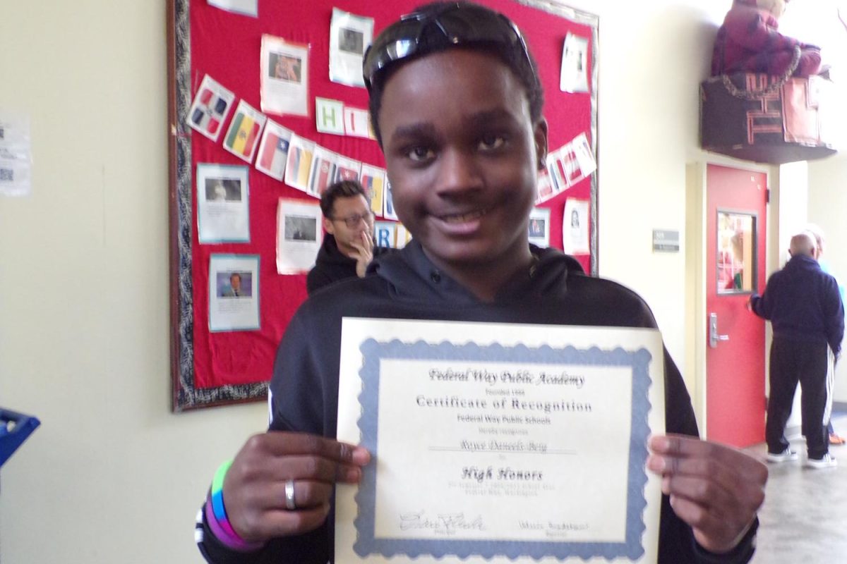 HARD WORK PAYS OFF!
Royce Daneels-Berg holds his certificate of High Honors right after receiving the award. This was an addition to the High Honors awards he had obtained in the past. “When they took the photo I felt proud of myself, I placed the award on my wall at home,” Royce stated.
