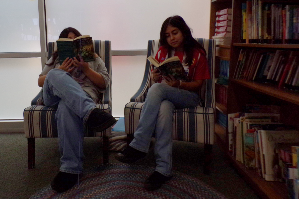 LOCKED IN 
Evasol Fernadez and Dannia Rogel Rojas are locked in while reading Percy Jackson and the Olympians. Evasol explained, “I like the book more than the show because I'm able to imagine how it looks and what they look like.” Dannia said the opposite, “I liked the show more because I didn't have to imagine what they are doing and I was able to focus more on the story the what they look like or what they are doing.”