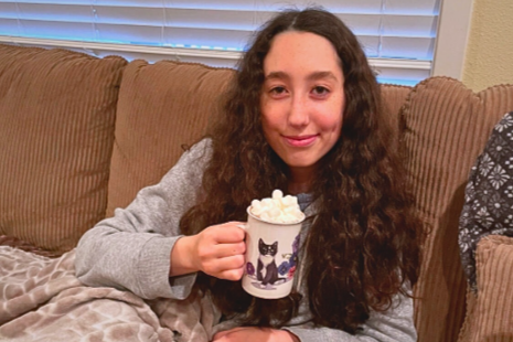 WINTER WISHES! 
Phoebe Farber sips her hot chocolate fireside. She’s always had a pretty big sweet tooth. “She’s well known for preferring her hot chocolates piled high with fluffy marshmallows,” her sister Shaina chuckles.