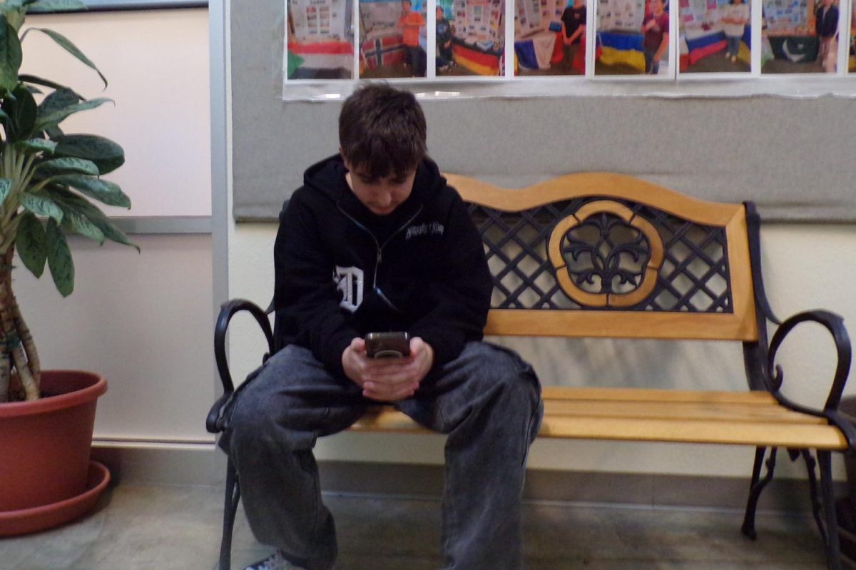 ALL FUN AND GAMES!
Alex Gasanov enjoys the highly played game, Clash Royale, on the school benches. Many kids have been seen playing the game, normally at lunch and after school. "I enjoy [Clash Royale]'s strategy," says Alex. "It makes you think and you have to be precise about things."
